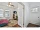 Charming bedroom with hardwood floors, a ceiling fan, a decorative rug, and abundant natural light at 811 E Flora St, Tampa, FL 33604