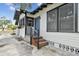Charming home entrance with porch, railing, and freshly painted blue door at 811 E Flora St, Tampa, FL 33604