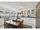Bright kitchen features white cabinets, stainless appliances, island with breakfast bar, and decorative rug at 811 E Flora St, Tampa, FL 33604
