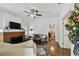 Bright living room with fireplace, ceiling fan, and hardwood floors at 811 E Flora St, Tampa, FL 33604