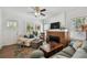 Inviting living room featuring a brick fireplace, hardwood floors and neutral decor at 811 E Flora St, Tampa, FL 33604