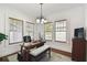 Bright office space with hardwood floors, a stylish desk, ample natural light, and a decorative chandelier at 811 E Flora St, Tampa, FL 33604