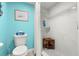 Bathroom featuring a tiled shower, shower seat, toilet and decorative art at 8141 Aquila St # 346, Port Richey, FL 34668