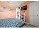 Cozy bedroom showing a bed, wall-mounted TV, and closet, creating a relaxing space at 8141 Aquila St # 346, Port Richey, FL 34668
