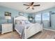 Bright bedroom with blue walls, a white bed, and two windows, perfect for relaxation at 8141 Aquila St # 346, Port Richey, FL 34668