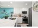 Updated kitchen featuring sleek stainless steel appliances, custom backsplash, and bright lighting at 8141 Aquila St # 346, Port Richey, FL 34668