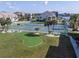 Community putting green and tennis courts surrounded by palm trees at 8141 Aquila St # 346, Port Richey, FL 34668