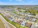 Aerial view of neighborhood and home showing community lake access, sidewalks and lush front and back yards at 8919 Drummer Plank Dr, Wesley Chapel, FL 33545