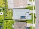 An aerial view of the home featuring an enclosed in-ground pool and lush back and side yards at 8919 Drummer Plank Dr, Wesley Chapel, FL 33545
