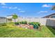 Landscaped back yard featuring a beautiful garden with raised garden beds and an archway in a fully fenced yard at 8919 Drummer Plank Dr, Wesley Chapel, FL 33545