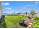 Back yard featuring a sprawling lawn, an open garden, and trees in this large fully fenced yard at 8919 Drummer Plank Dr, Wesley Chapel, FL 33545