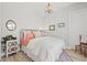 Bright bedroom with decorative rug, wood accents and window with sheer curtains at 8919 Drummer Plank Dr, Wesley Chapel, FL 33545