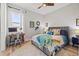 This bedroom has a ceiling fan, area rug and desk with natural light from the window at 8919 Drummer Plank Dr, Wesley Chapel, FL 33545