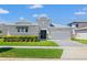 Charming single-Gathering home featuring manicured lawn and beautiful landscaping under a sunny sky at 8919 Drummer Plank Dr, Wesley Chapel, FL 33545