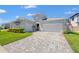 Charming single-Gathering home featuring manicured lawn and beautiful landscaping under a sunny sky at 8919 Drummer Plank Dr, Wesley Chapel, FL 33545