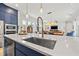 Bright and open kitchen features modern appliances, a large island, and stylish pendant lighting fixtures at 8919 Drummer Plank Dr, Wesley Chapel, FL 33545