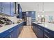 Stunning kitchen featuring navy cabinets, stainless steel appliances, and bright countertops with an eat-in kitchen island at 8919 Drummer Plank Dr, Wesley Chapel, FL 33545