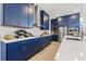 Beautiful kitchen boasting navy cabinets, quartz countertops, stainless steel appliances and stylish accents at 8919 Drummer Plank Dr, Wesley Chapel, FL 33545