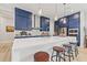 Modern kitchen with navy cabinets, stainless steel appliances, a quartz countertop, and eat-in kitchen island with seating at 8919 Drummer Plank Dr, Wesley Chapel, FL 33545