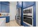 Well-equipped kitchen features stainless steel appliances, striking navy cabinets, and ample storage space at 8919 Drummer Plank Dr, Wesley Chapel, FL 33545