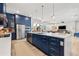 Spacious open kitchen boasts a large island, stainless steel appliances, with an open-concept view to the living spaces at 8919 Drummer Plank Dr, Wesley Chapel, FL 33545
