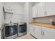 Functional laundry room equipped with modern appliances, storage cabinets, and a wood countertop at 8919 Drummer Plank Dr, Wesley Chapel, FL 33545