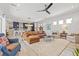 Open-concept living area with kitchen, dining and large living area, modern furniture and plenty of natural light at 8919 Drummer Plank Dr, Wesley Chapel, FL 33545