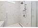 Modern shower with sleek fixtures, a built-in shower seat, and elegant marble-look tiling at 8919 Drummer Plank Dr, Wesley Chapel, FL 33545