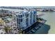 A high-angle view of a pristine waterfront condominium, featuring private boat docks, ample parking, and waterfront views at 9525 Blind Pass Rd # 508, St Pete Beach, FL 33706