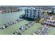 Stunning waterfront condo building with private boat docks, surrounded by lush landscaping and sparkling waterways at 9525 Blind Pass Rd # 508, St Pete Beach, FL 33706
