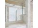 Neutral bathroom with an extended vanity and seashell wallpaper at 9525 Blind Pass Rd # 508, St Pete Beach, FL 33706