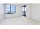 Spacious bedroom with a large window and glass doors leading to balcony at 9525 Blind Pass Rd # 508, St Pete Beach, FL 33706