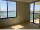 Bedroom featuring expansive water views, and sliding glass door to balcony at 9525 Blind Pass Rd # 508, St Pete Beach, FL 33706