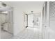 Hallway with tile flooring, a bathroom, and multiple closet spaces at 9525 Blind Pass Rd # 508, St Pete Beach, FL 33706