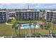 Beautiful view of the condo community featuring a pool, boat docks, and manicured green space at 9815 Harrell Ave # 502, Treasure Island, FL 33706