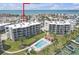 Beautiful aerial view of condos showcasing a pool, manicured lawns, and marina access at 9815 Harrell Ave # 502, Treasure Island, FL 33706