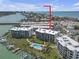 Expansive aerial view of waterfront condos, marina, pool and nearby gulf coast beaches at 9815 Harrell Ave # 502, Treasure Island, FL 33706