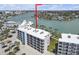 Desirable aerial view featuring waterfront condo with pool and easy beach access at 9815 Harrell Ave # 502, Treasure Island, FL 33706