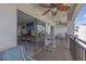 Balcony featuring a ceiling fan and outdoor seating areas with interior views at 9815 Harrell Ave # 502, Treasure Island, FL 33706