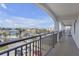 Balcony featuring railings with city views and parking lot, plus glimpses of the ocean at 9815 Harrell Ave # 502, Treasure Island, FL 33706