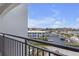 Balcony featuring railings with city views and parking lot with palm trees at 9815 Harrell Ave # 502, Treasure Island, FL 33706