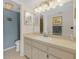 Bathroom with a large mirror, spacious vanity, and modern lighting fixtures at 9815 Harrell Ave # 502, Treasure Island, FL 33706
