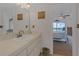 Bathroom featuring a large mirror with view into main bedroom and balcony at 9815 Harrell Ave # 502, Treasure Island, FL 33706