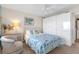 Bedroom with white wardrobes, a side chair and an ocean themed quilt at 9815 Harrell Ave # 502, Treasure Island, FL 33706