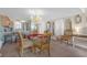 Dining area open to the kitchen, featuring a glass-top table with ornate chairs, and decorative mirrors at 9815 Harrell Ave # 502, Treasure Island, FL 33706