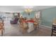 Open-concept dining area with glass table, ornate chairs, and a view into the living space at 9815 Harrell Ave # 502, Treasure Island, FL 33706