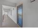 Hallway showcasing a blue front door with glass and a glimpse of balcony views at 9815 Harrell Ave # 502, Treasure Island, FL 33706