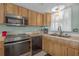 Updated kitchen featuring stainless steel appliances, light wood cabinetry, and a cozy breakfast nook at 9815 Harrell Ave # 502, Treasure Island, FL 33706