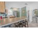 Well-lit kitchen with an island bar, stainless steel appliances, and light-colored wooden cabinetry at 9815 Harrell Ave # 502, Treasure Island, FL 33706