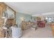 Comfortable living room featuring a stone fireplace, plush seating, and easy access to dining at 9815 Harrell Ave # 502, Treasure Island, FL 33706